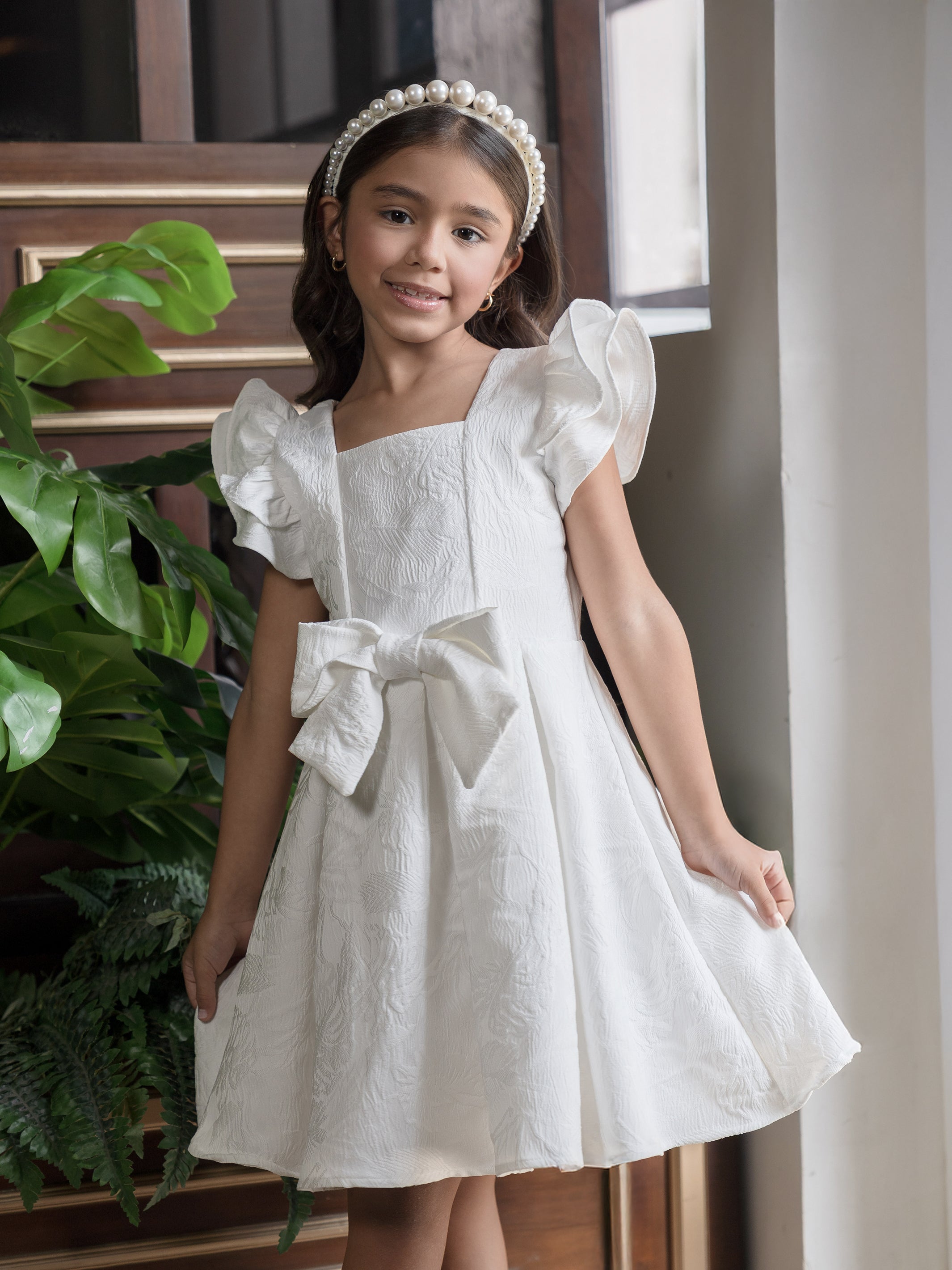 Vestido de niña en jacquard con lazo frontal
